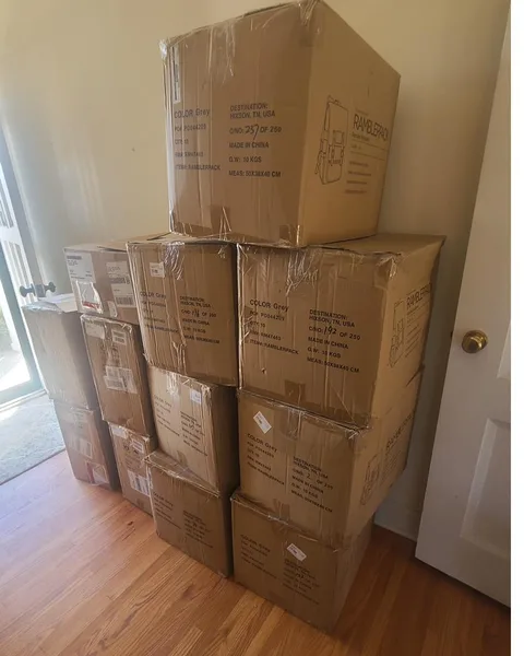 Cartons of components stacked in a living room